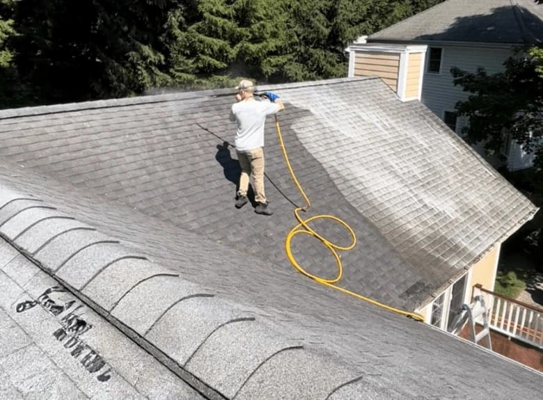 Wadsworth Power Washing professional cleaning and inspecting gutters on Wadsworth home